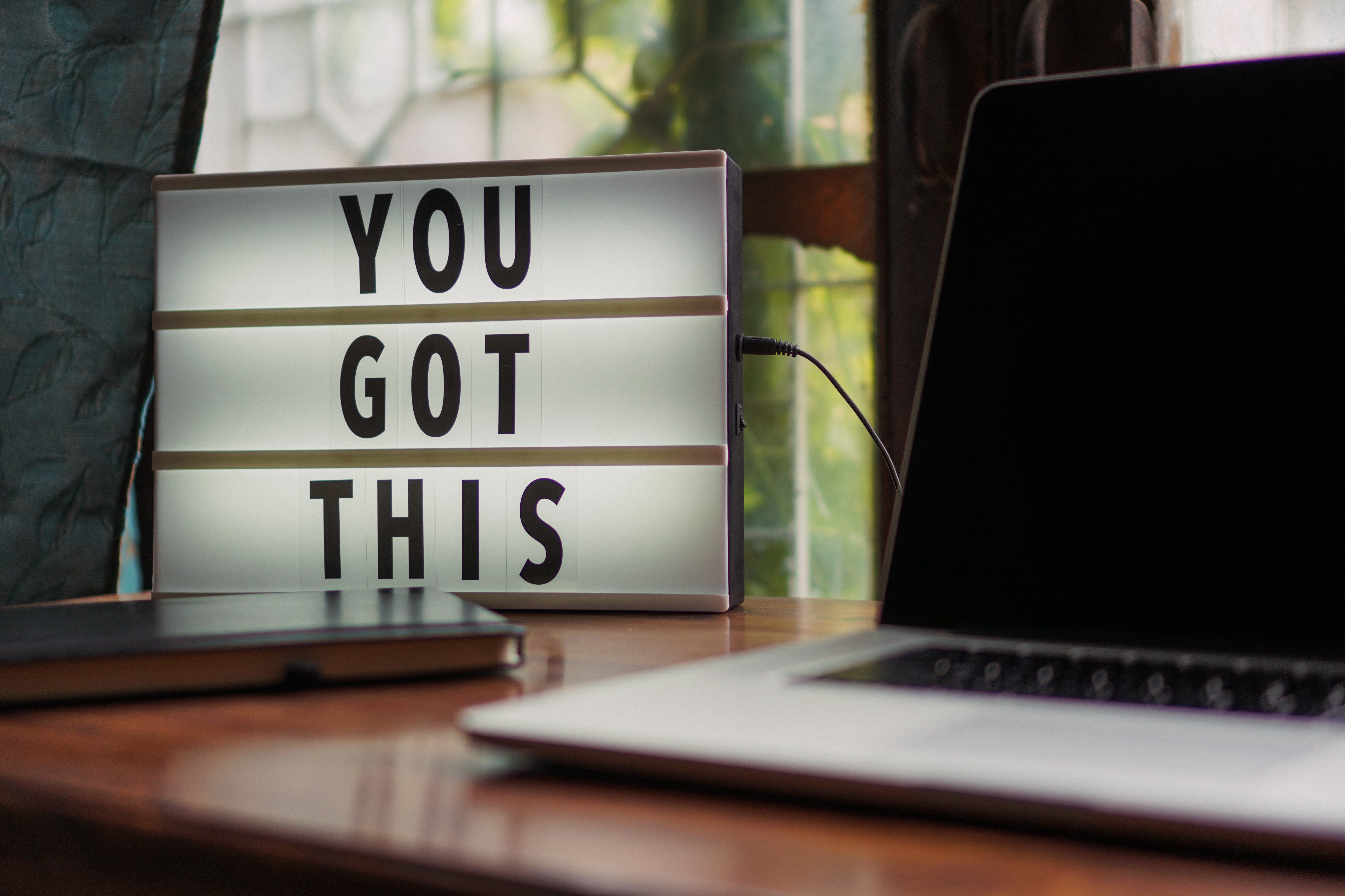 Sign saying "You got this" next to black computer screen. To remind writers how to face rejection.