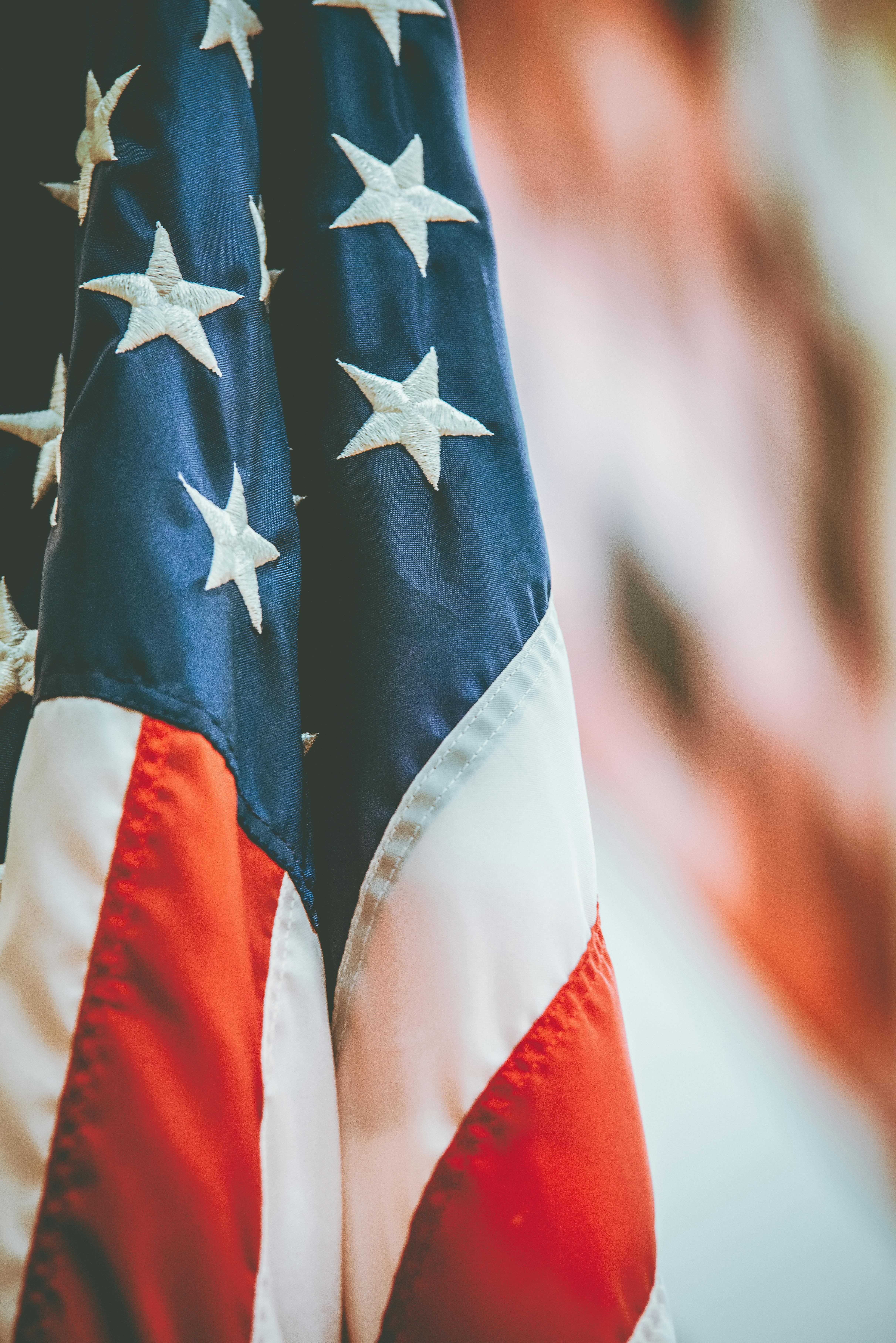 Close up of American flag on a blurred background; offering discounts to veterans beginning Veterans Day 2024