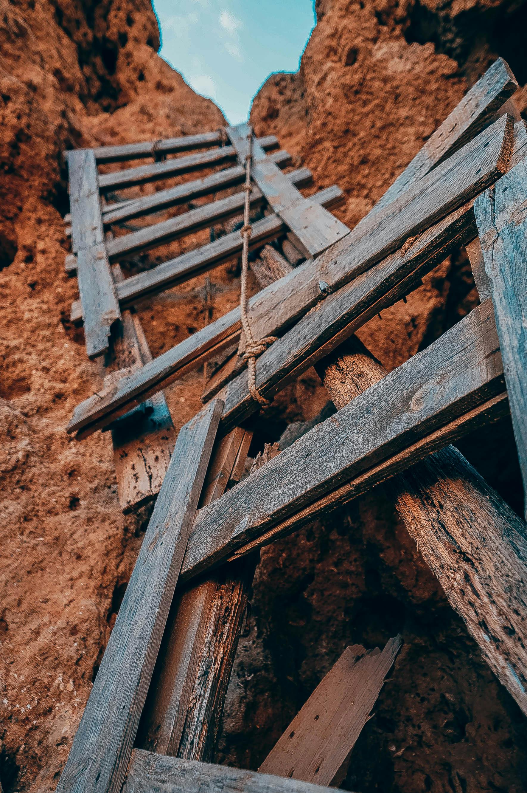 A broken ladder leads up a stiff cliff; advice for writing the Ordeal in your novel